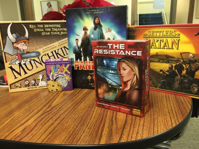 Five Board Games Sitting On a Table