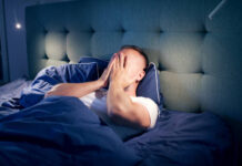 Man trying to sleep but experiencing a restless night. Creator: janiecbros Credit: Getty Images